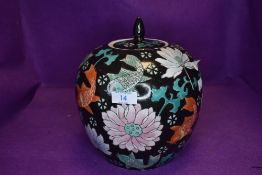 A Chinese ginger jar of large form having black ground with carp and peony decoration