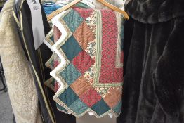A vintage patchwork quilt or bed throw