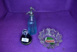 A garage advertising ashtray for Castrol and similar art glass paper weight