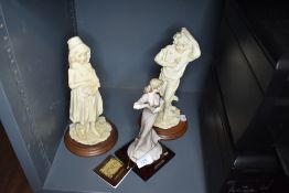Three figurines including dancing lady.