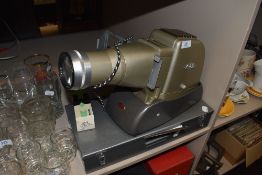A selection of photographic slides and an Aldis projector lamp