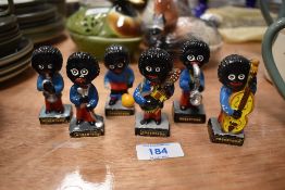 Six vintage Robertsons advertising figures including musicians and footballer