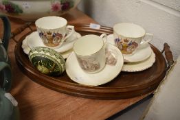 An antique wooden tray and a selection of commemorative ware.