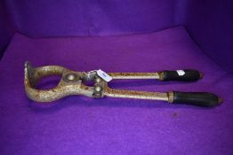 A set of bygone farm implement bull castration grip or imasculator