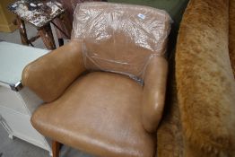 A 70's style office arm chair in beige tan vinyl