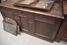A Period oak kist , having partially carved front with three panels, dimensions approx. W125 D57