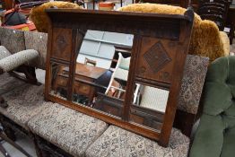 A traditional carved oak over mantel or similar wall mirror