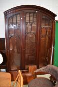 A large three part display or book case having Gothic design arched door frames
