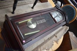 A reporduction mahogany effect wall clock