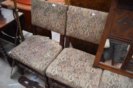 A set of four priory style oak dining chairs