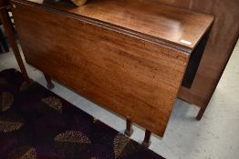 A 19th Century mahogany gateleg dining table on tapered legs, shaped apron