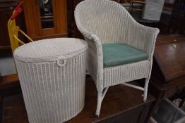 A Lloyd Loom tubchair and similar oval laundry basket
