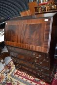 A modern dark stained bureau having four under drawer