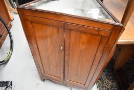 An interesting oak triangular corner cupboard having illusionary bijouterie top, possibly having