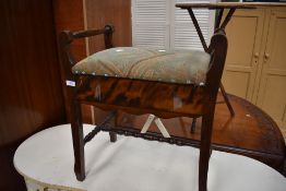 A piano stool with lift up storage seat