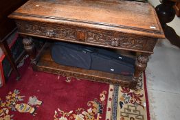A late Victorian carved oak hall way refectory table having green man handles