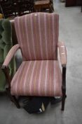A carver dining room chair with mahogany frame and corduroy seat