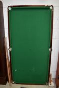 A medium sized snooker table having fold out metal frame and complimentary balls and cues