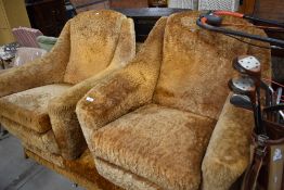 A mid century lounge suit having space age design frame with tangerine orange shag upholstery some