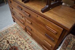 A teak sideboard/chest of eight drawer