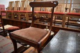 A set of four mahogany framed dining chairs having carved seat backs