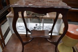 A mahogany hall way wash stand having curved frame work and shelf