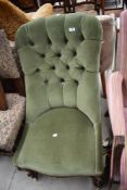 A 19th Century button back nursing chair on knurl mahogany frame