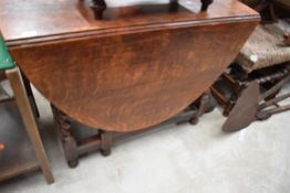 A traditional oak gate leg kitchen table having twist legs