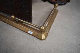 A brass fire fender, width approx. 85cm internally