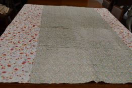 A large vintage quilt having floral section used throughout and backed in white cotton.