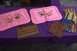 A selection of ethnic styled fabrics a vintage bag of similar style and two pink Chinese embroidered