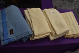 A collection of vintage wool blankets including blue blanket and CC41 labelled utility blanket.