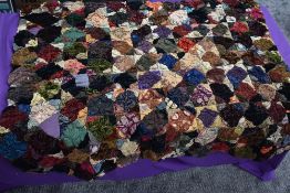 An unusual throw/quilt having a variety of raised sections of fabric, around mid to late 19th