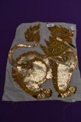 An oriental embroidered and sequinned panel.