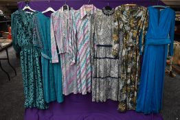 An assortment of vintage and retro Ladies clothing in a variety of colours,styles and eras including