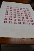 A pink and white patchwork quilt, having pattern to front and plain white reverse, some age staining