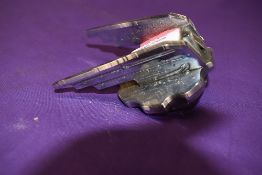 A vintage motor car engine hood badge for Wolsey