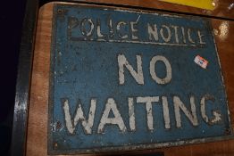 A vintage cast metal sign for No Waiting Police Notice