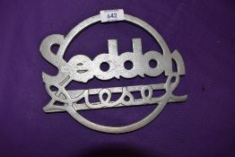 A reproduction cast metal commercial radiator badge for Seddon