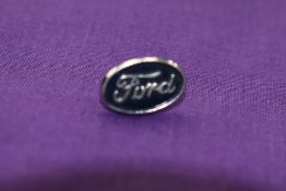 A Ford lapel badge.
