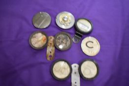 A selection of vintage motor car tax disk holders