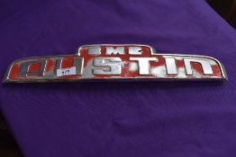 A BMC Austin cab badge.
