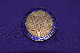 A veteran car club lapel badge.