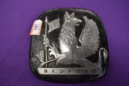 A vintage Bedford truck engine badge with gryphon emblem