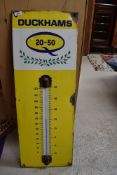 An enamel garage advertising sign thermometer for Duckhams Oil