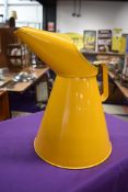 A vintage garage five litre oil can in yellow
