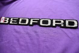 A vintage Bedford truck engine badge
