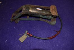 A vintage garage car foot pump