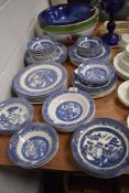 A good selection of various blue and white willow wear plates and bowls