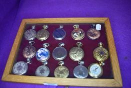 A glazed display case containing fifteen pocket watches or time pieces